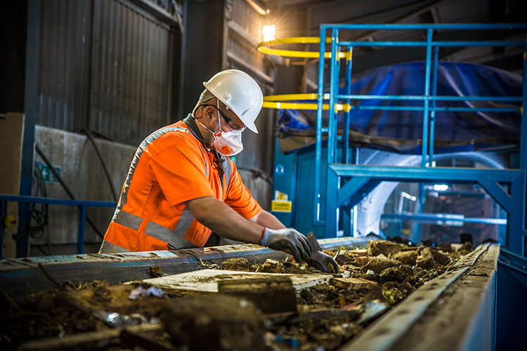 TJ Waste worker at recycling and waste disposal facility
